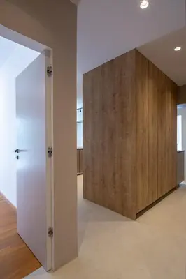 an open door in a room with a wooden wall at Hippocrates - Faliro deluxe apartment in Athens