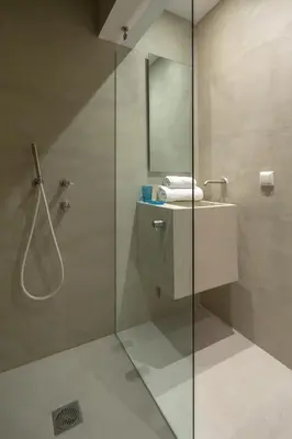 a bathroom with a glass shower and a sink at Hippocrates - Faliro deluxe apartment in Athens