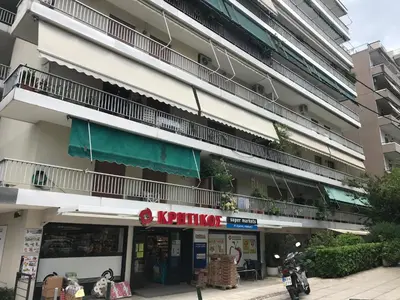 an apartment building with a balcony on the side of it at Hippocrates - Faliro deluxe apartment in Athens