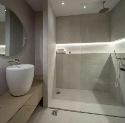 a bathroom with a white sink and a shower at Hippocrates - Faliro deluxe apartment in Athens
