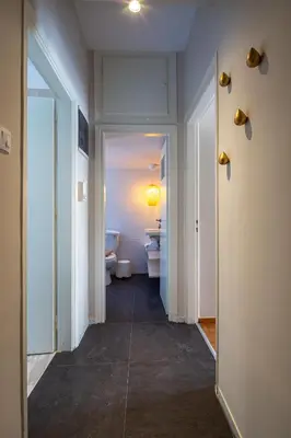 a hallway of a bathroom with a toilet and a sink at Demetra - Koukaki center apartment in Athens