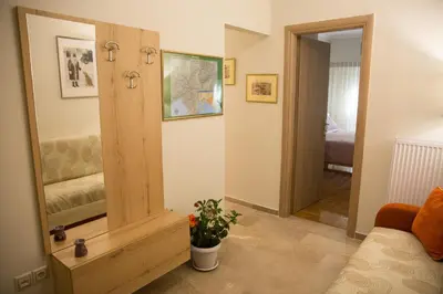a living room with a mirror and a couch at Ivannas dream house in Athens