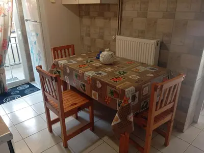a dining room table with a table cloth and chairs at Antonia family house near Airport in Porto Rafti