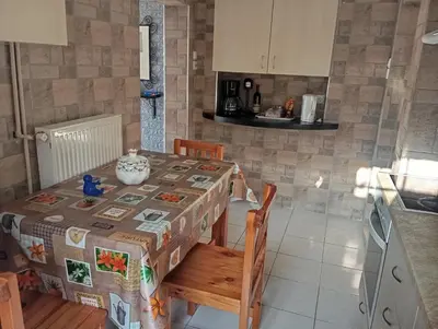 a kitchen with a table with a table cloth on it at Antonia family house near Airport in Porto Rafti