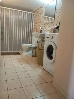 a bathroom with a washing machine and a toilet at Antonia family house near Airport in Porto Rafti