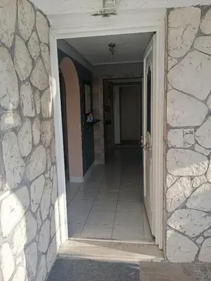 a hallway of a house with a door leading to a room at Antonia family house near Airport in Porto Rafti