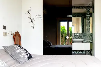 a bedroom with a bed and a sink and a mirror at The Burton Luxury 1BR in Plaka, Athens in Athens