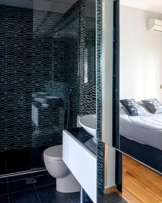 a bathroom with a bed and a toilet and a sink at The Burton Luxury 1BR in Plaka, Athens in Athens