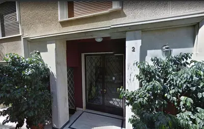 a front door of a house with a tree at The Burton Luxury 1BR in Plaka, Athens in Athens