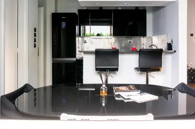 a glass table with two chairs sitting on top of it at The Burton Luxury 1BR in Plaka, Athens in Athens