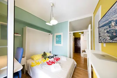 a room with a bed and a room with a table at Startupper's Pad in real Athenian neighbourhood in Athens