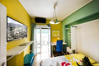a bedroom with yellow and green walls and a desk at Startupper's Pad in real Athenian neighbourhood in Athens