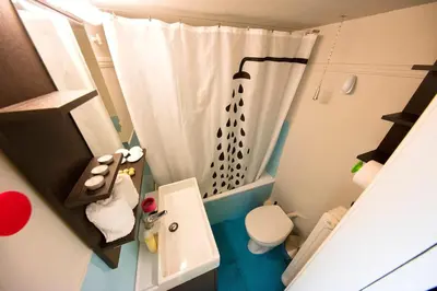 a small bathroom with a shower and a toilet at Startupper's Pad in real Athenian neighbourhood in Athens