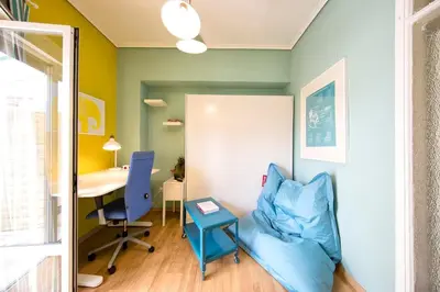 an office with a blue chair and a desk at Startupper's Pad in real Athenian neighbourhood in Athens