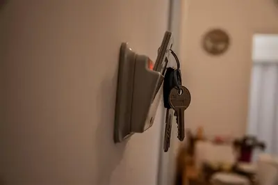 a pair of keys hanging on a refrigerator door at Your apartment in Athens (Next to Metro & Acropolis) in Athens