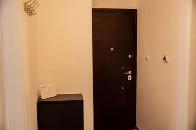 a black door in the corner of a room at Your apartment in Athens (Next to Metro & Acropolis) in Athens