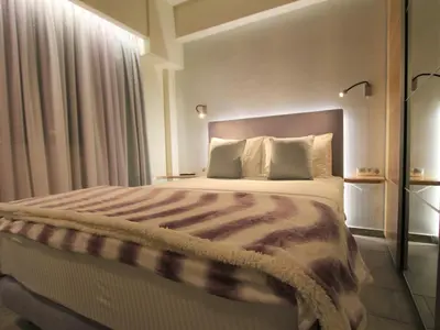 a bedroom with a large bed in a room at Aiolos Apartments Ermou 64 Monastiraki, Plaka 4th floor in Athens
