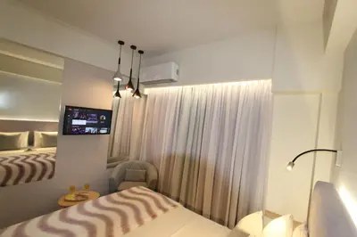 a hotel room with a bed and a tv at Aiolos Apartments Ermou 64 Monastiraki, Plaka 4th floor in Athens