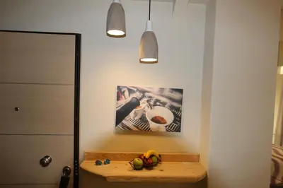 a room with a table and a picture on the wall at Aiolos Apartments Ermou 64 Monastiraki, Plaka 4th floor in Athens