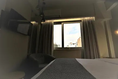 a bedroom with a bed and a window at Aiolos Apartments Ermou 64 Monastiraki, Plaka 4th floor in Athens