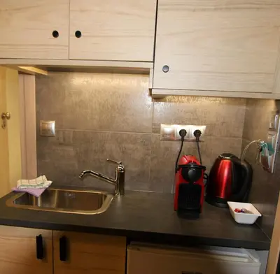 a kitchen counter top with a sink and a kitchen at Aiolos Apartments Ermou 64 Monastiraki, Plaka 4th floor in Athens