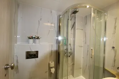 a bathroom with a shower with a glass shower stall at Aiolos Apartments Ermou 64 Monastiraki, Plaka 4th floor in Athens