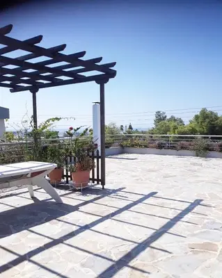 a picnic table and a bench on a patio at Fantastic villa, a 5 minute drive from the beach! in Athens