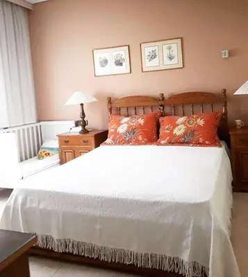 a bedroom with a large bed with orange pillows at Fantastic villa, a 5 minute drive from the beach! in Athens