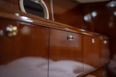 a wooden cupboard with a mirror on top of it at Boat Aiolis in the Athenian Riviera! in Athens