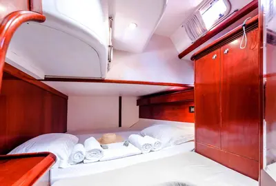 a small room with a bed and towels at Boat Aiolis in the Athenian Riviera! in Athens