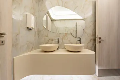 a bathroom with two sinks and a mirror at Green Suites Boutique Hotel in Athens