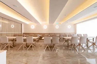 a conference room with tables and chairs and a large window at Green Suites Boutique Hotel in Athens