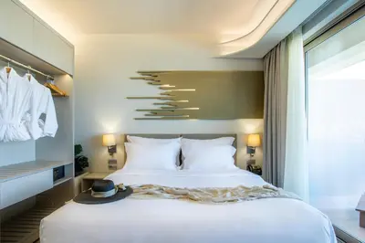 a bedroom with a large white bed and a window at Green Suites Boutique Hotel in Athens