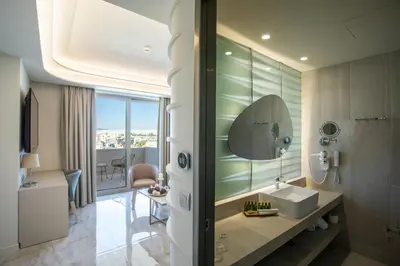 a bathroom with a sink and a mirror at Green Suites Boutique Hotel in Athens