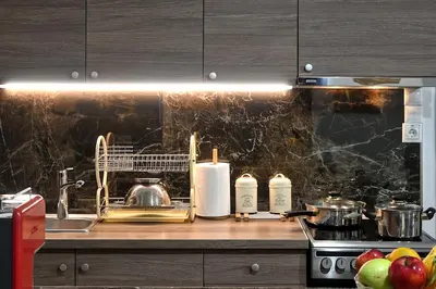 a kitchen with a counter with a sink and a stove at Stylish Apartment, Acropolis view in Athens
