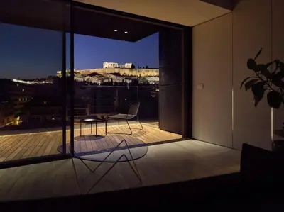 a balcony with a table and a view of the city at Urban Stripes Athens in Athens