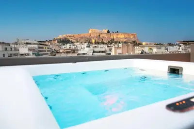 a bath tub with a view of the city at Urban Stripes Athens in Athens