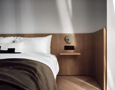 a bedroom with a bed and a clock on the wall at Urban Stripes Athens in Athens