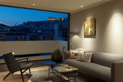 a living room with a couch and a large window at Urban Stripes Athens in Athens