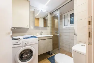 a bathroom with a washing machine and a sink at Athens Studio in Athens