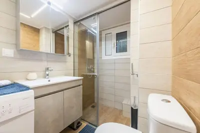 a bathroom with a toilet and a sink and a shower at Athens Studio in Athens