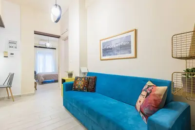 a blue couch sitting in a living room at Athens Studio in Athens