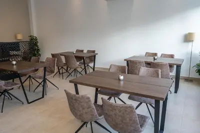 a group of tables and chairs in a room at HOTEL HILL in Athens