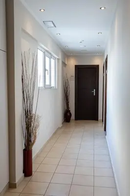an empty hallway with a door and a tile floor at HOTEL HILL in Athens