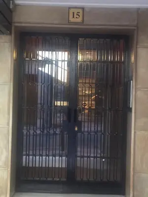 a metal door with the number on it at Dimitras Apartment in Athens
