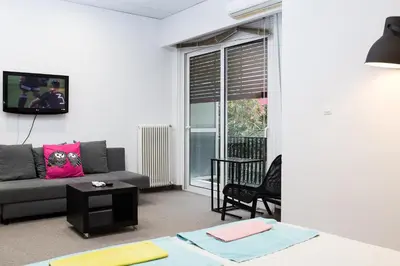 a living room with a couch and a table at Dimitras Apartment in Athens