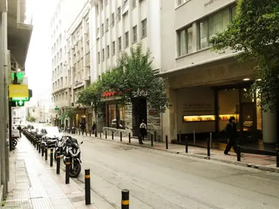 a city street with motorcycles parked on the side of the road at Dimitras Apartment in Athens