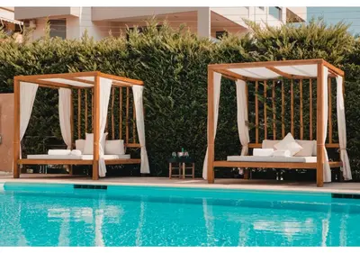 two chairs and a gazebo next to a pool at Blue Note Resort & Club in Athens