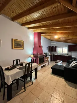 a living room with a table and a couch at House near the Athens Airport, Spata. in Spáta
