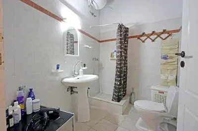 a bathroom with a sink and a toilet and a shower at House near the Athens Airport, Spata. in Spáta
